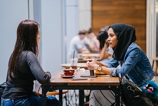 Two  women chatting over coffee at a cafe