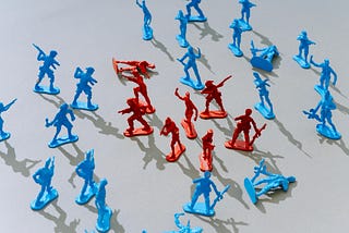 Plastic toy soldiers in red and blue appear to wage a battle
