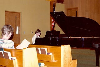 Piano teacher Mrs. Kiffmeyer instructing Gentry Bronson just prior to a piano performance