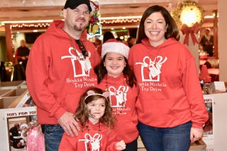 The writer and his family dressed in matching toy drive sweatshirts.