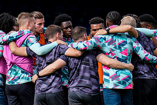 luton players in a huddle before the Wolves game