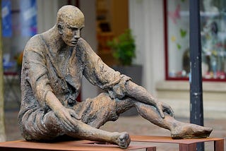 Statue of a man sitting down