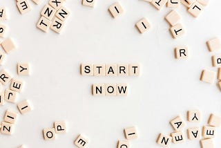 Scrabble tiles that in the middle say “Start Now”