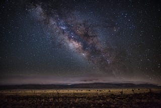 Night sky with milky way visible. On open desert.
