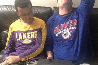 My son and I sitting on soft and watching game … me reacting to a missed shot.