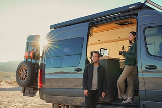 Mercedes Sprinter 4x4 campervan with man and woman drinking tea