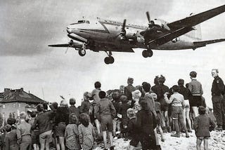 Historic image of C54 flying into Berlin over the heads of onlookers