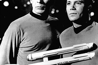 Image of Capt. Kirk and Mr. Spock with a miniature model of the Starship Enterprise