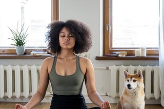 A woman and her dog meditation together. Meditation can change the brain structure and chemistry.