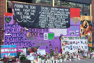 An image of multiple murals, signs and graffiti from Seattle’s CHAZ/CHOP protest zone in 2020. Signs say things like “Amnesty for all looters, rioters and protesters” and “Abolish the police” as well as memorials for Black people like George Floyd who had been killed by the police leading up to the protests.
