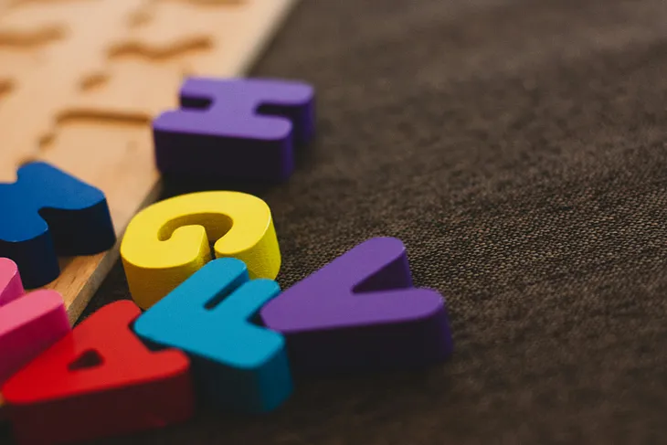 A few letters scattered out of a kid’s puzzle (H, G, F, A V).
