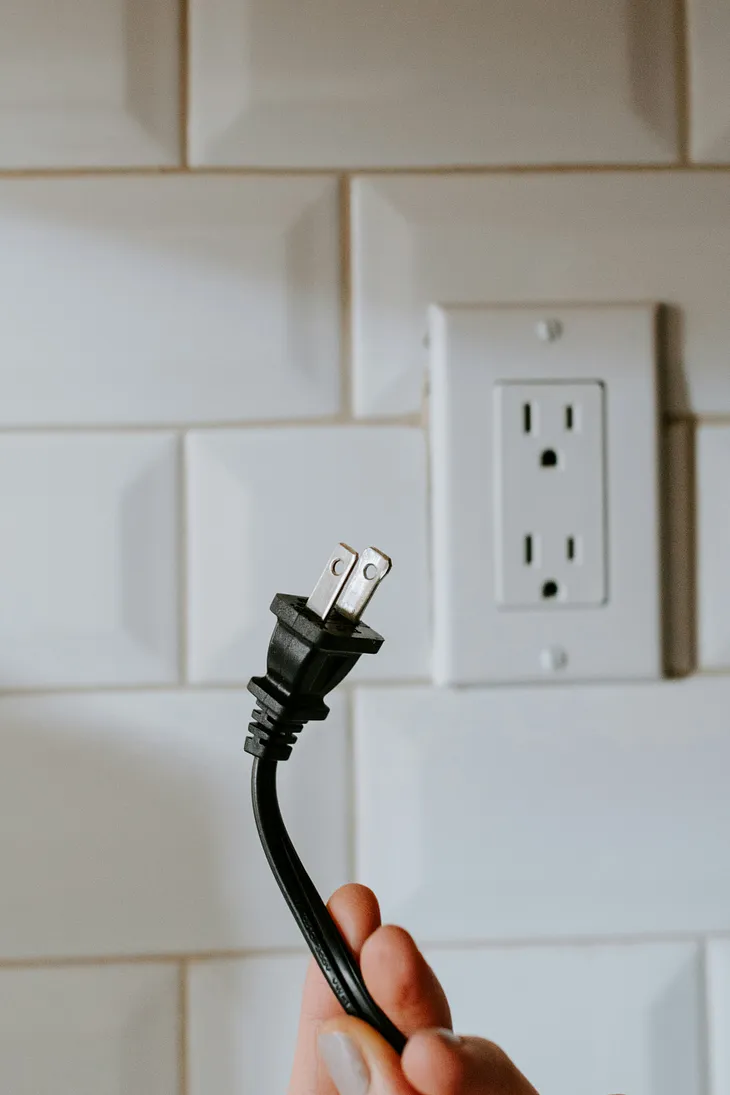 Plug dangling by outlet.