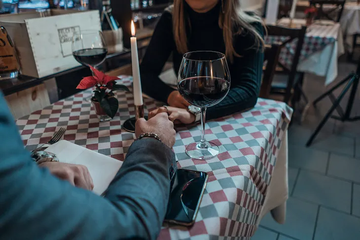 Couple holding hands in a restaurant.
