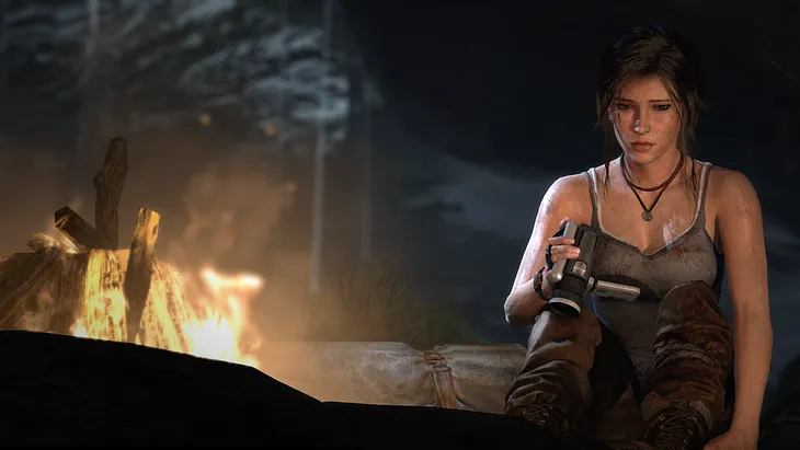 Lara Croft contemplates a camcorder near a campfire in Tomb Raider Definitive Edition.