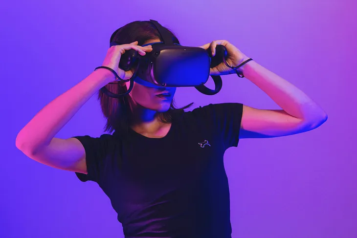 A woman leans back looking through a VR headset.