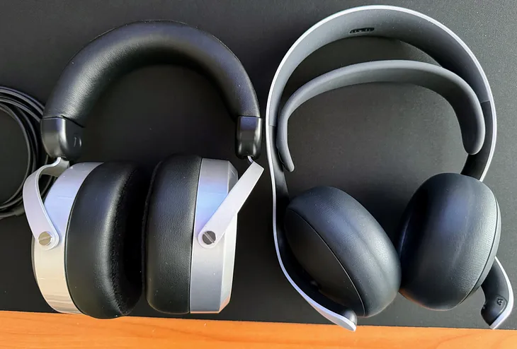 HiFiMan HE400SE headphones and a Pulse Elite gaming headset next to each other on a desk mat.