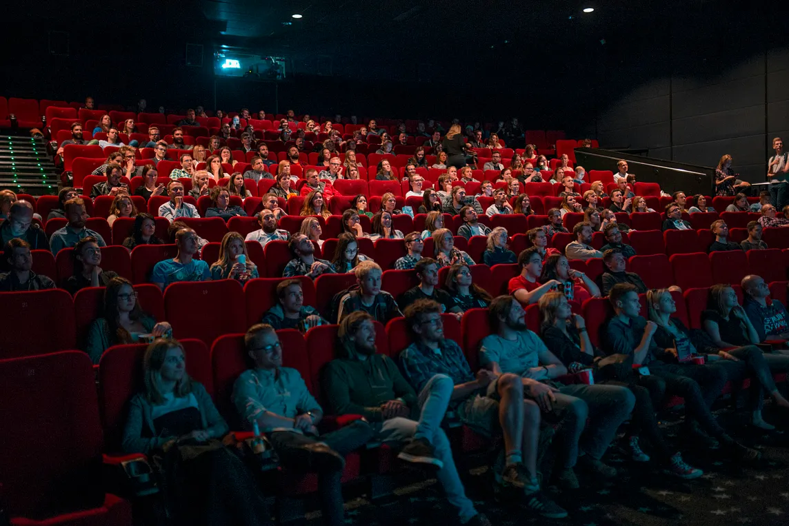 A cinema room filled with people looking towards the screen.